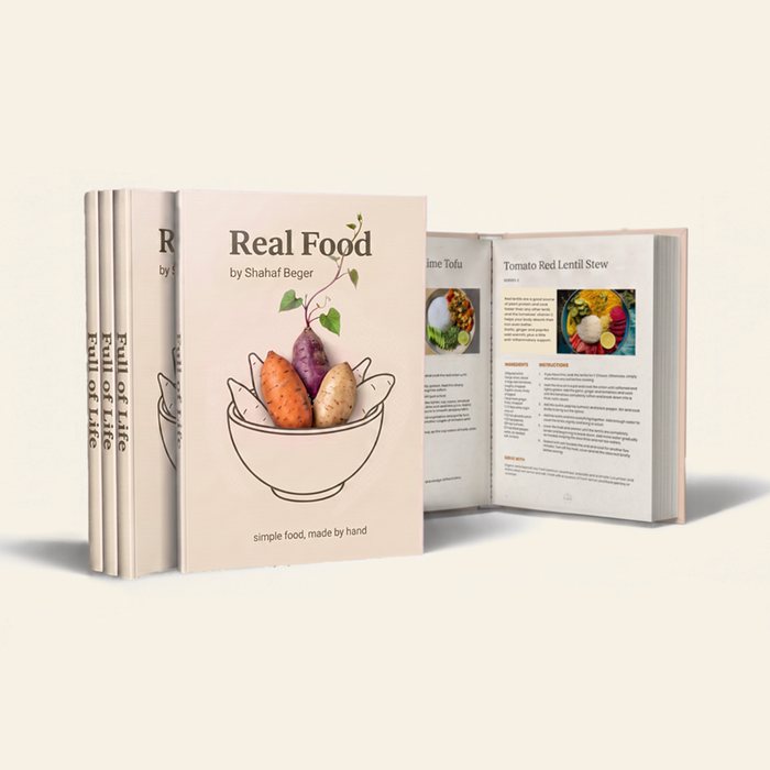 The Real Food book shown closed and open, revealing a recipe spread.